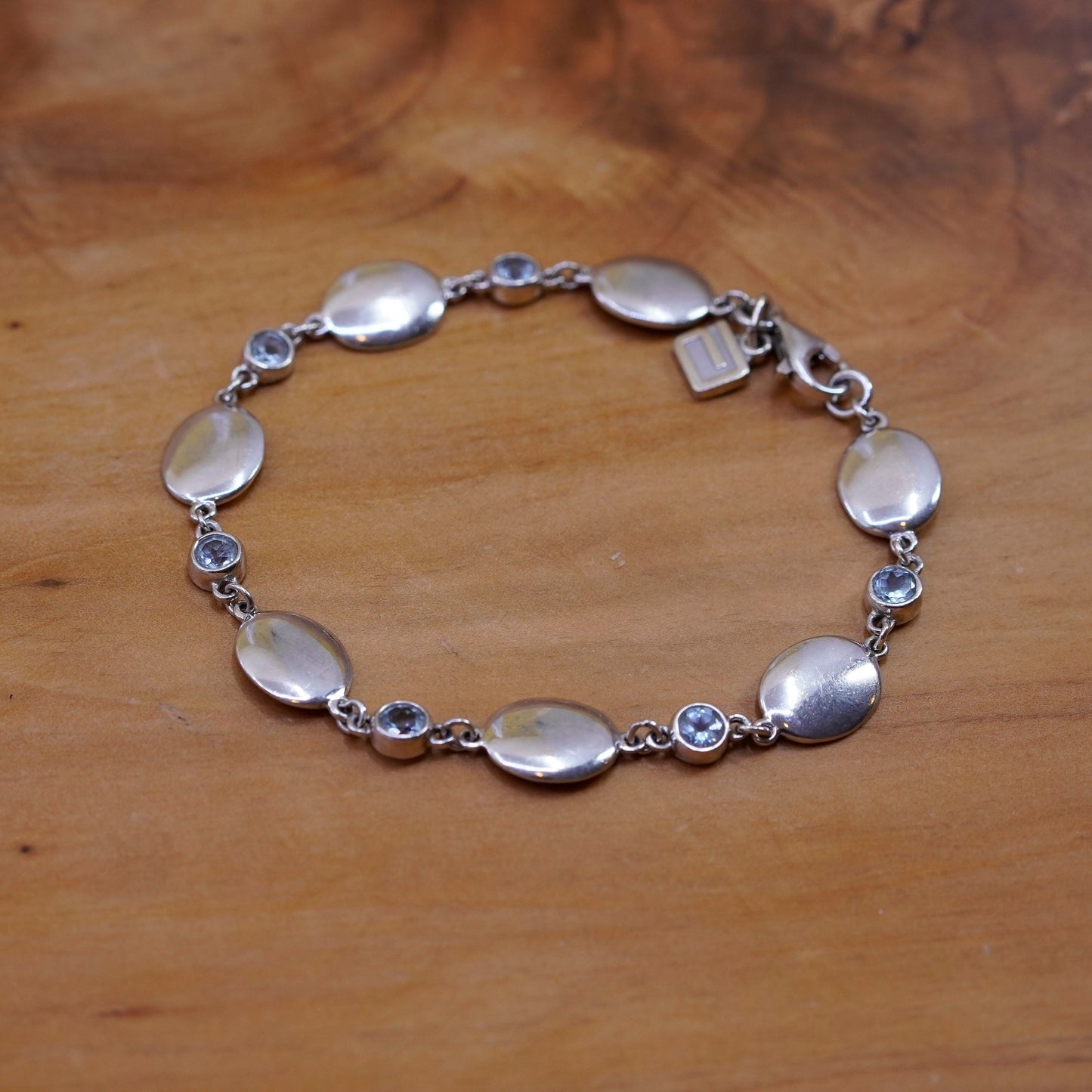 7.25”, Sterling silver bracelet, 925 oval chain with 10K gold charm and topaz