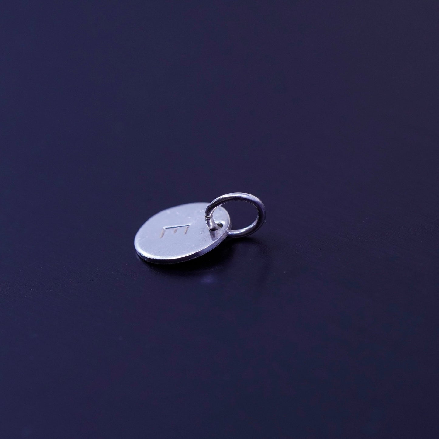 Antique Sterling silver charm, tiny 925 circle tag embossed initial “E”