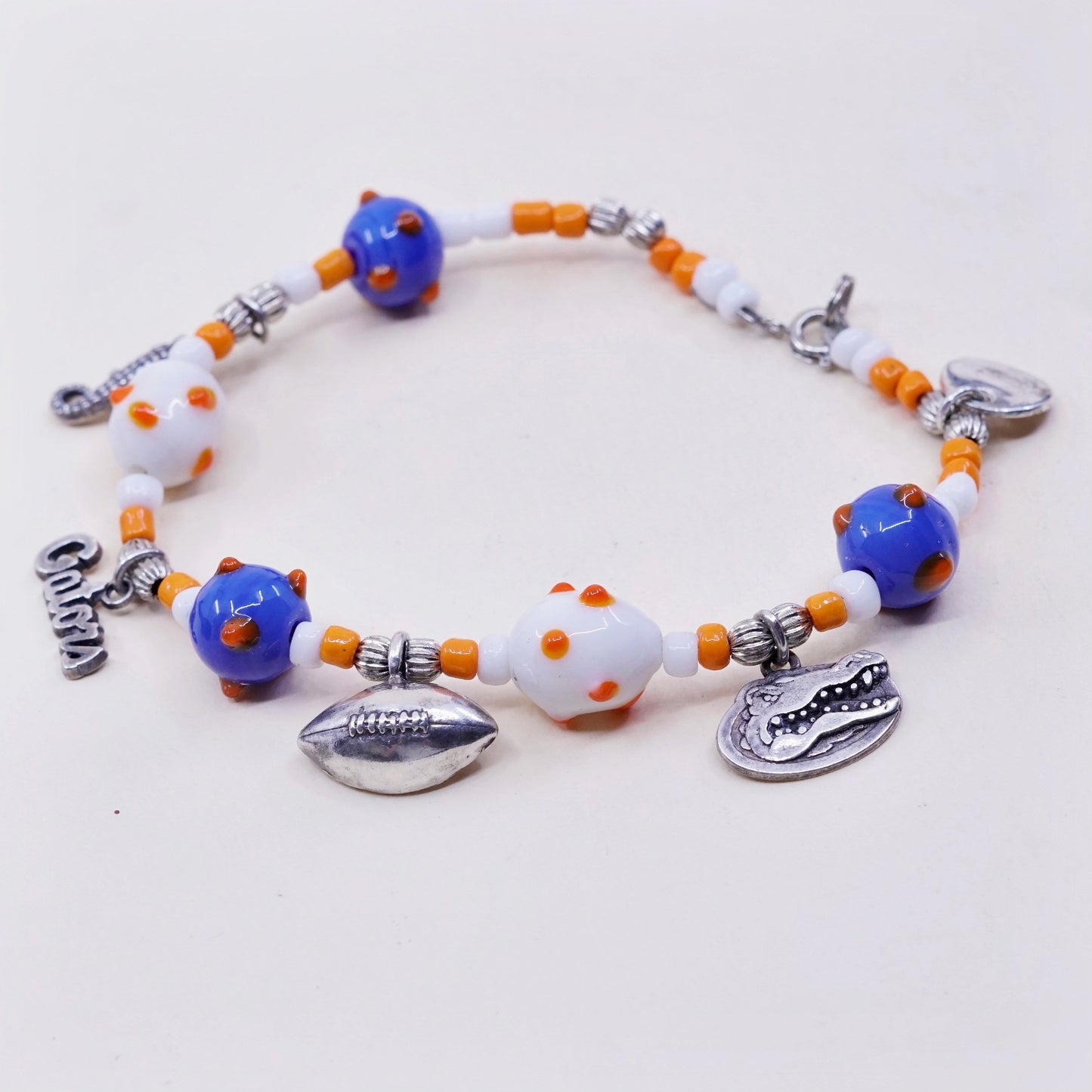 7.75”, blue and orange glass beads w/ sterling 925 silver alligator football