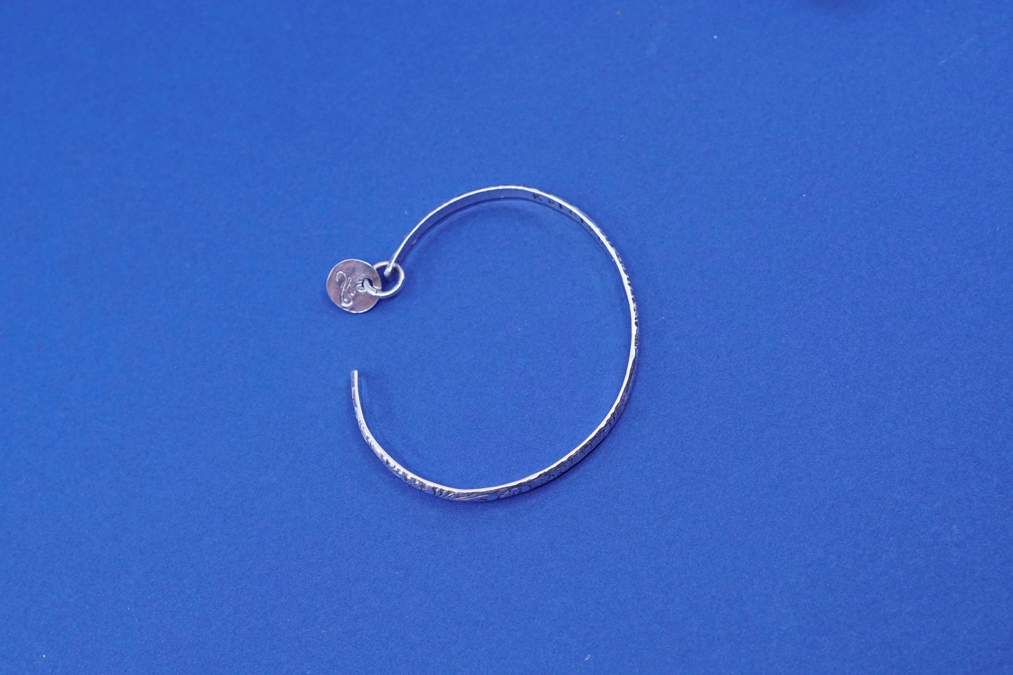 6.75”, sterling silver handmade bracelet, 925 textured cuff w/ “K” charm