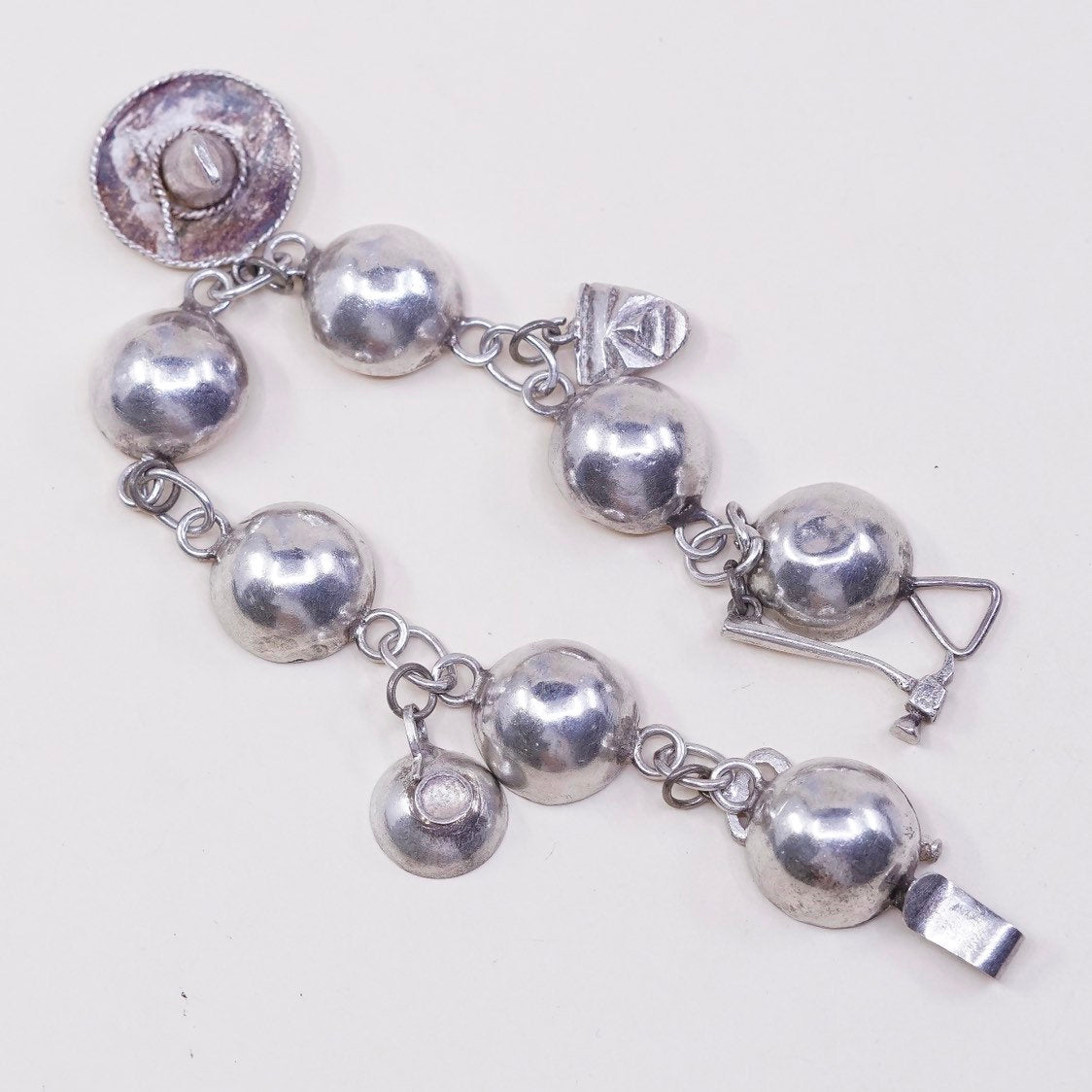 6”, sterling silver Handmade circle bracelet w/ hammer pot hat key sombrero