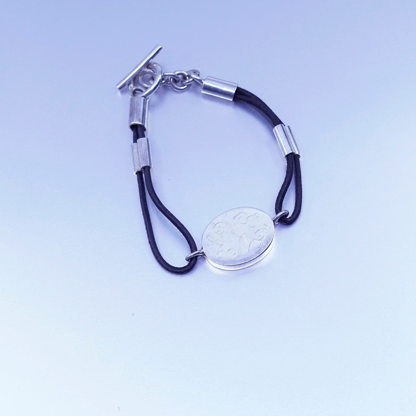 6.75”, sterling 925 silver handmade monogram “LKK” bracelet black leather core