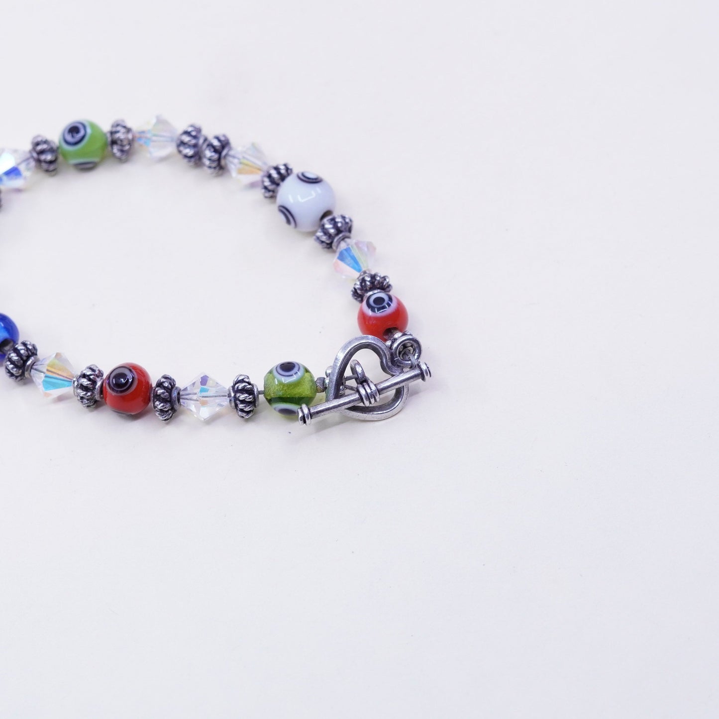 7”, handmade sterling silver bracelet, glass evil eye beads and heart closure