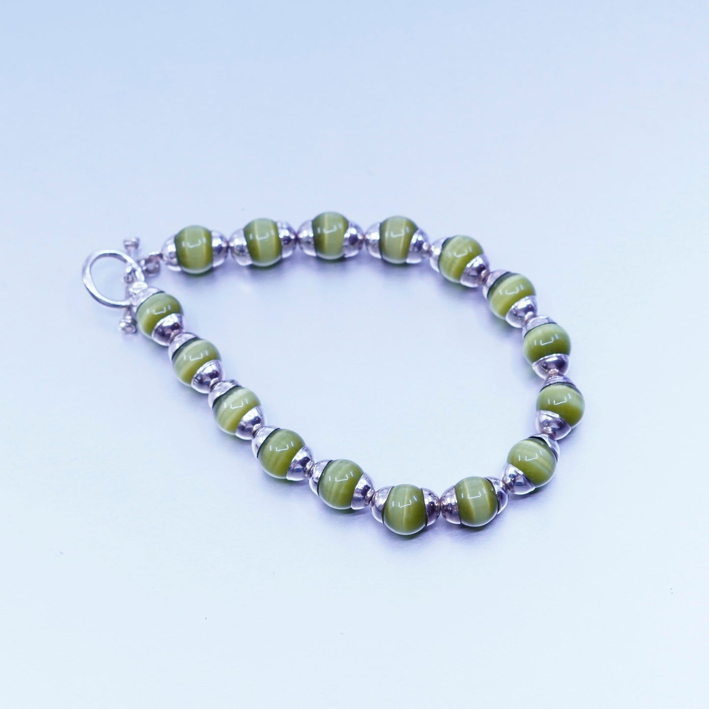 6.5”, Sterling 925 silver bracelet with green cat’s eye beads toggle closure