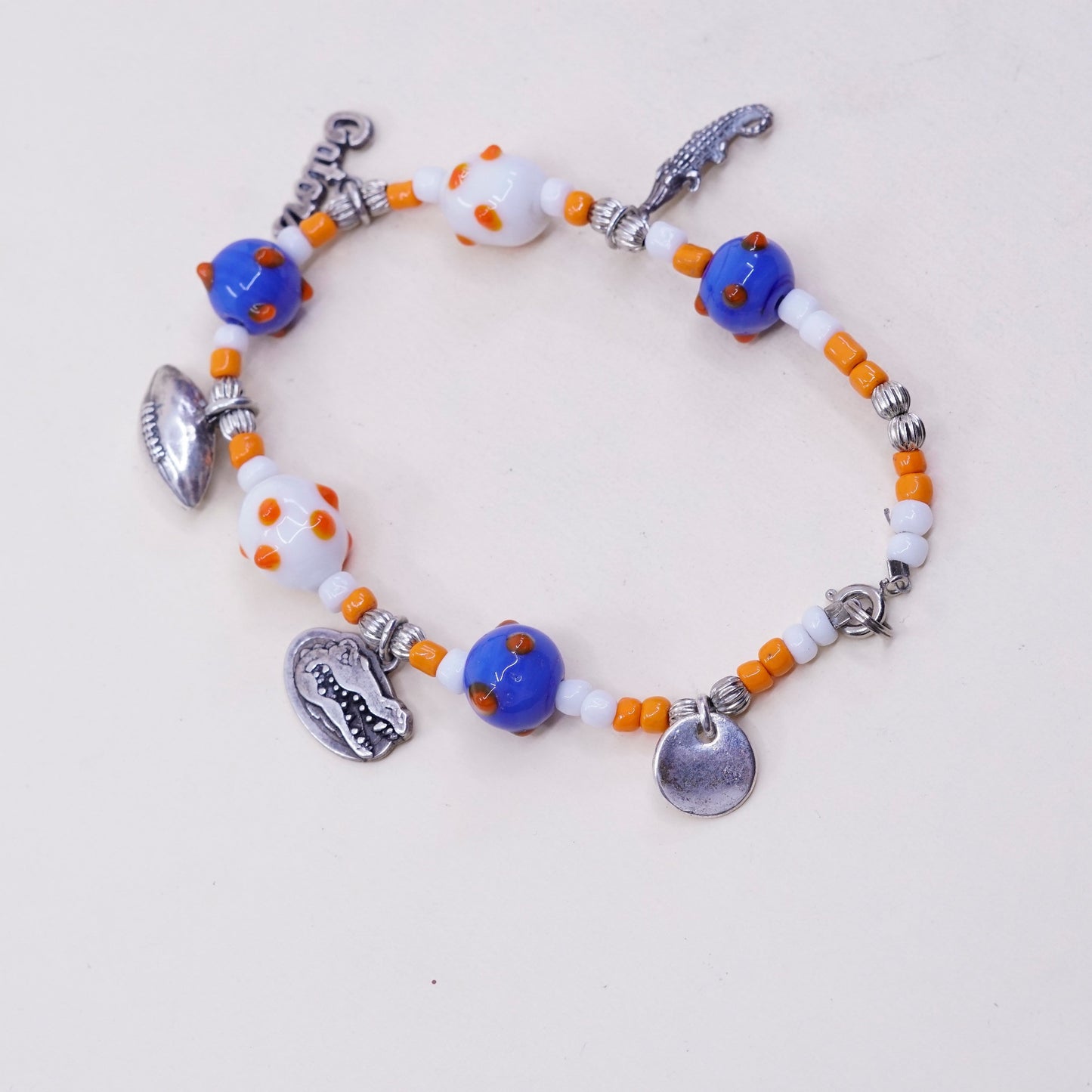 7.75”, blue and orange glass beads w/ sterling 925 silver alligator football