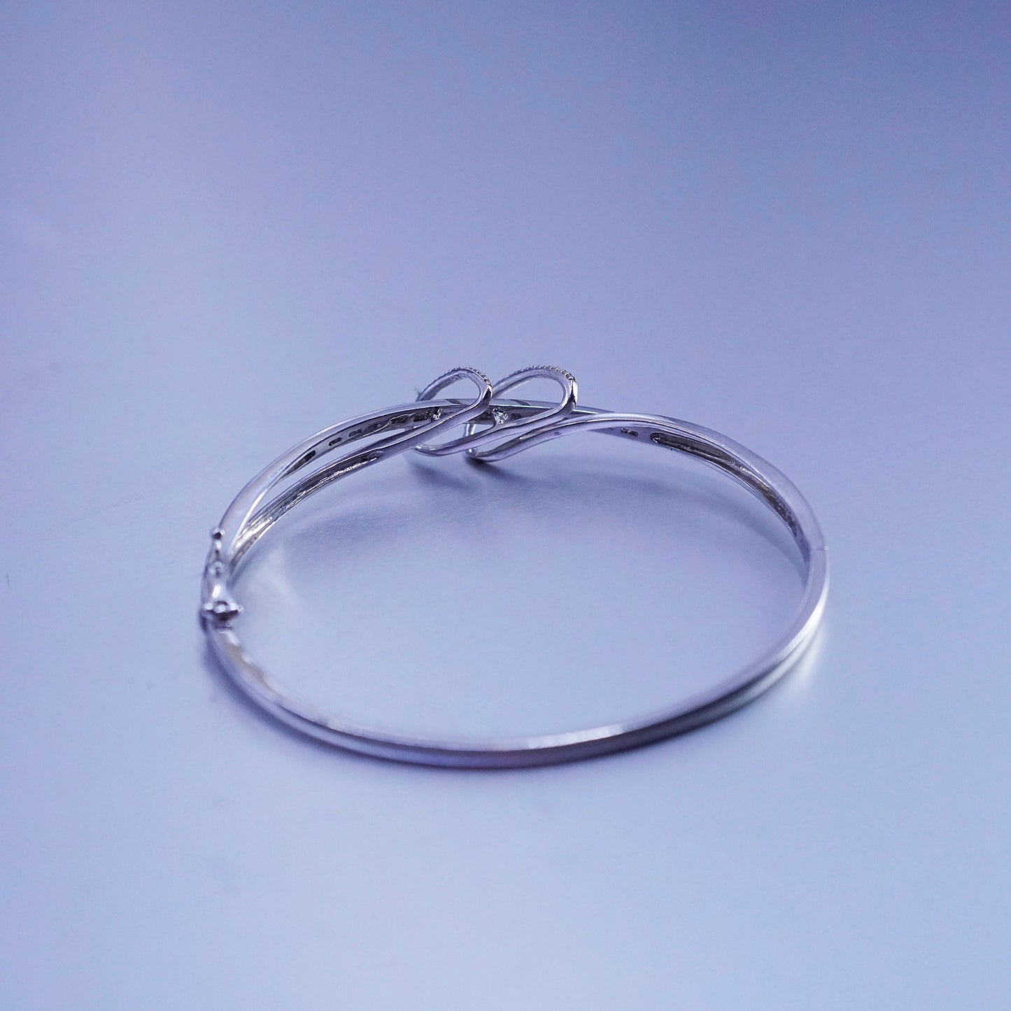 7”, Sterling 925 silver bracelet, entwined hinged bangle with cluster diamonds