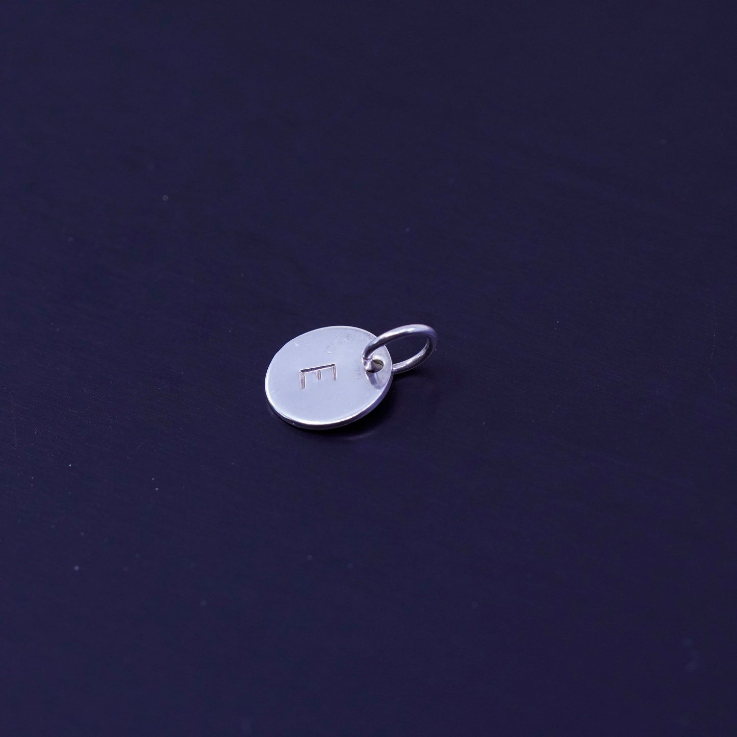 Antique Sterling silver charm, tiny 925 circle tag embossed initial “E”