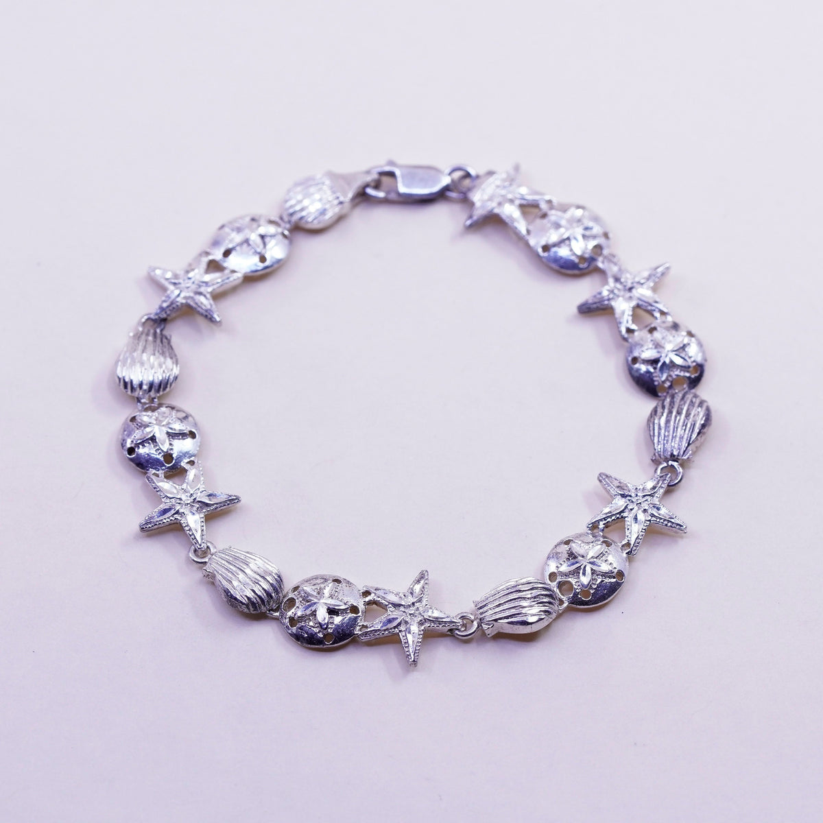 7.75”, ocean lover Sterling silver bracelet, 925 sand dollar, shell, starfish