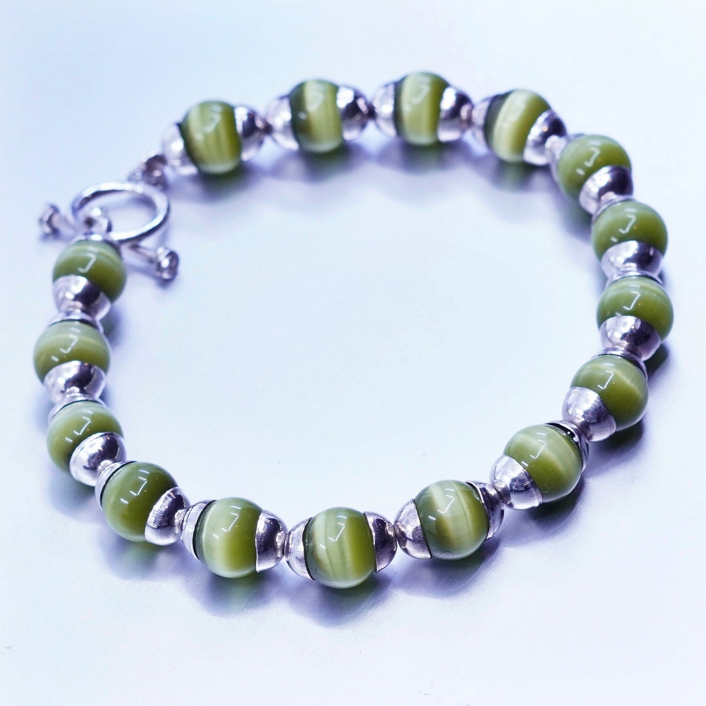 6.5”, Sterling 925 silver bracelet with green cat’s eye beads toggle closure
