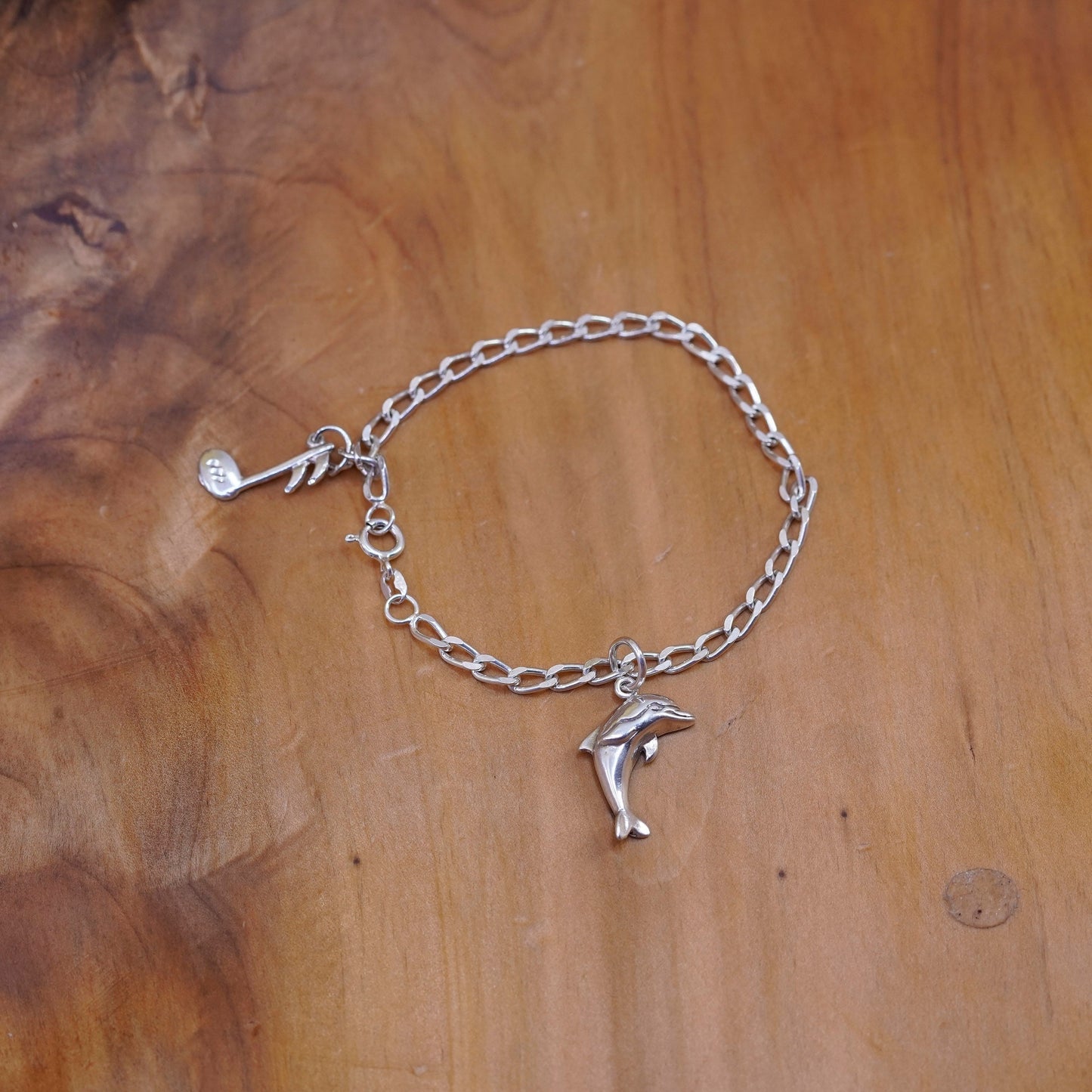 6.75”, Sterling silver bracelet, 925 curb chain with dolphin music note charms