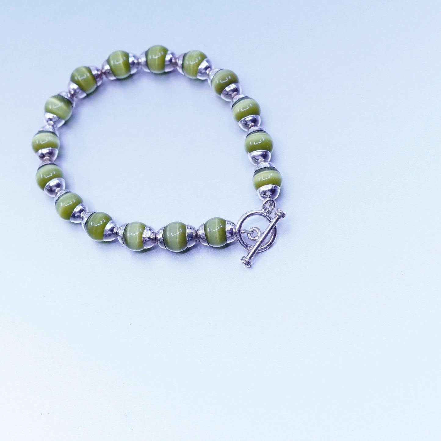6.5”, Sterling 925 silver bracelet with green cat’s eye beads toggle closure