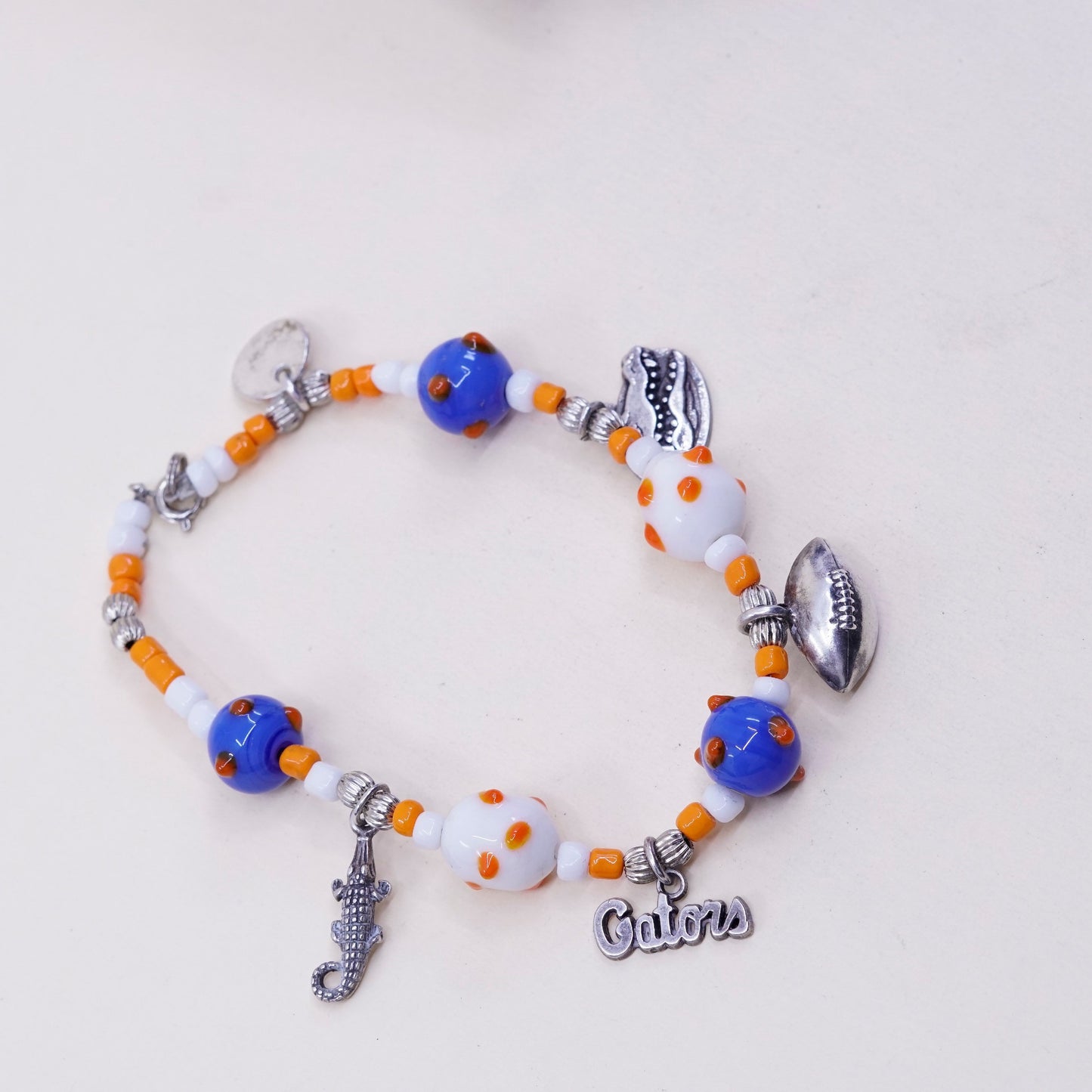 7.75”, blue and orange glass beads w/ sterling 925 silver alligator football