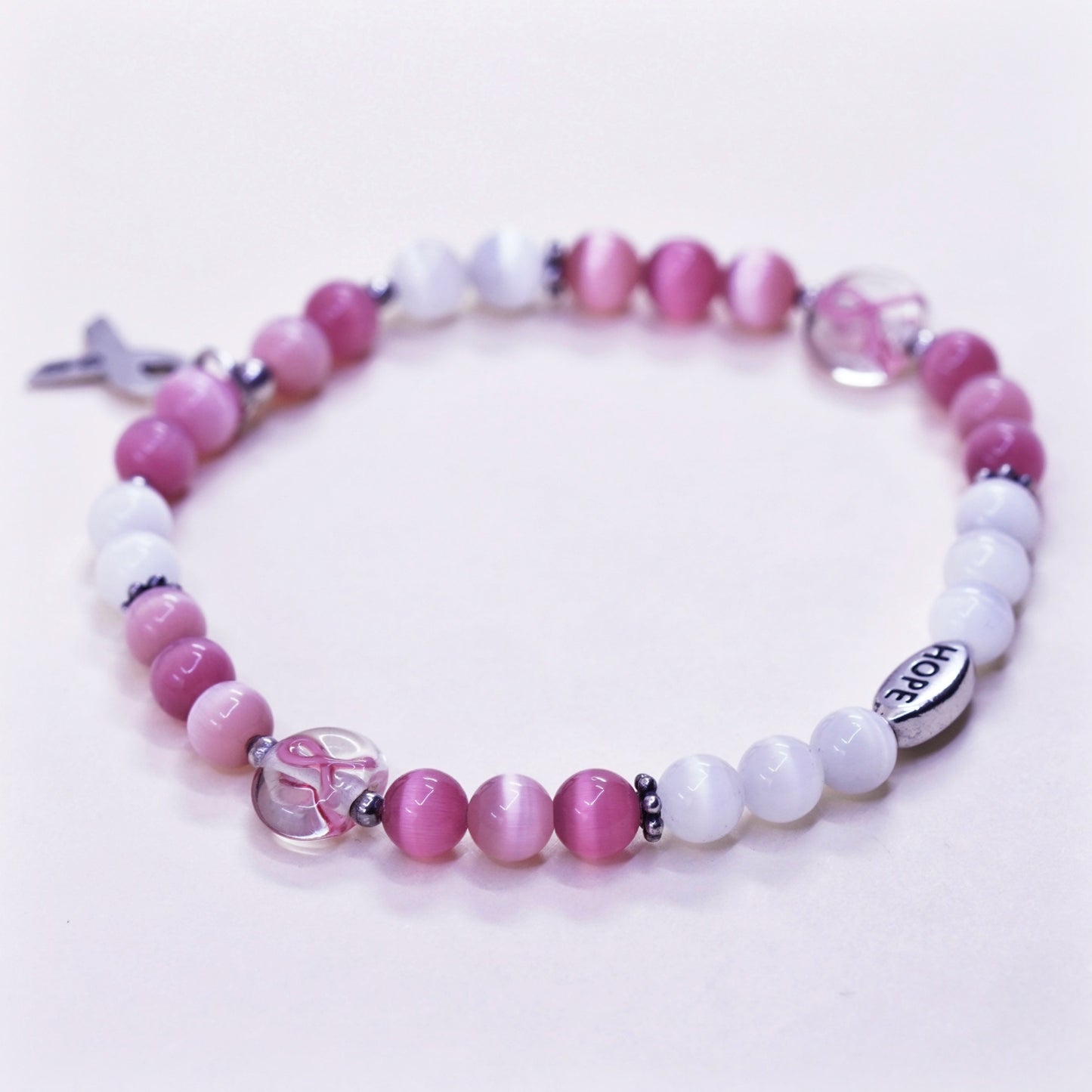 7.5”, “Hope” bracelet, pink cats eye beads elastic band 925 ribbon bow tie