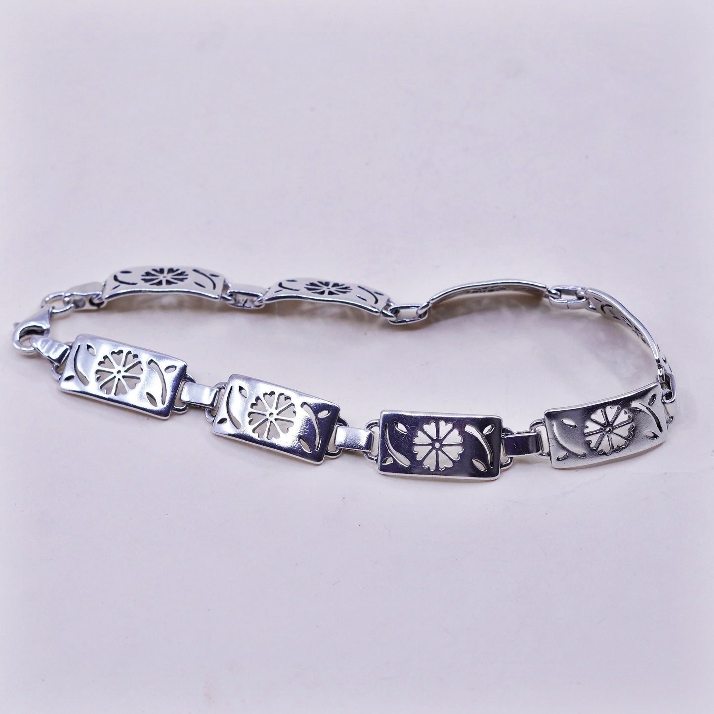 7.75”, sterling silver tennis bracelet, textured 925 chain with flower cut out