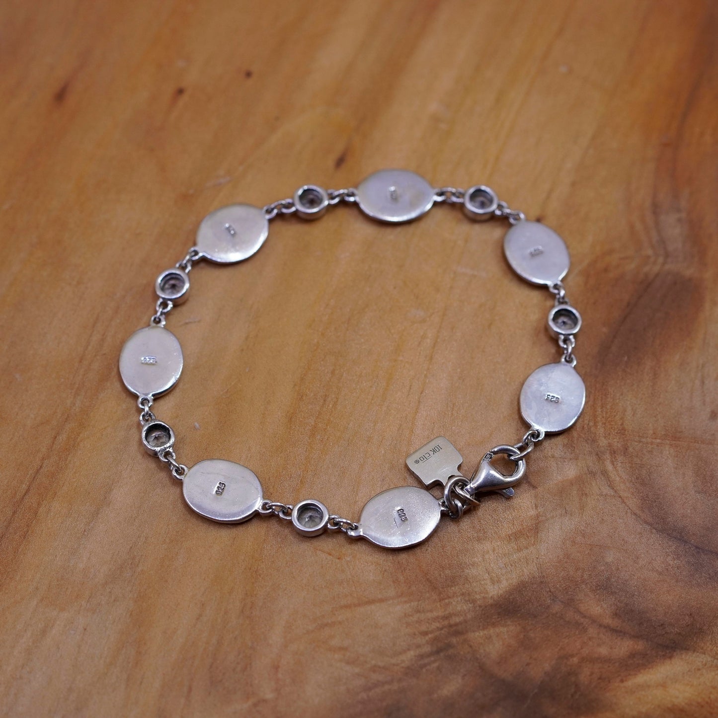 7.25”, Sterling silver bracelet, 925 oval chain with 10K gold charm and topaz