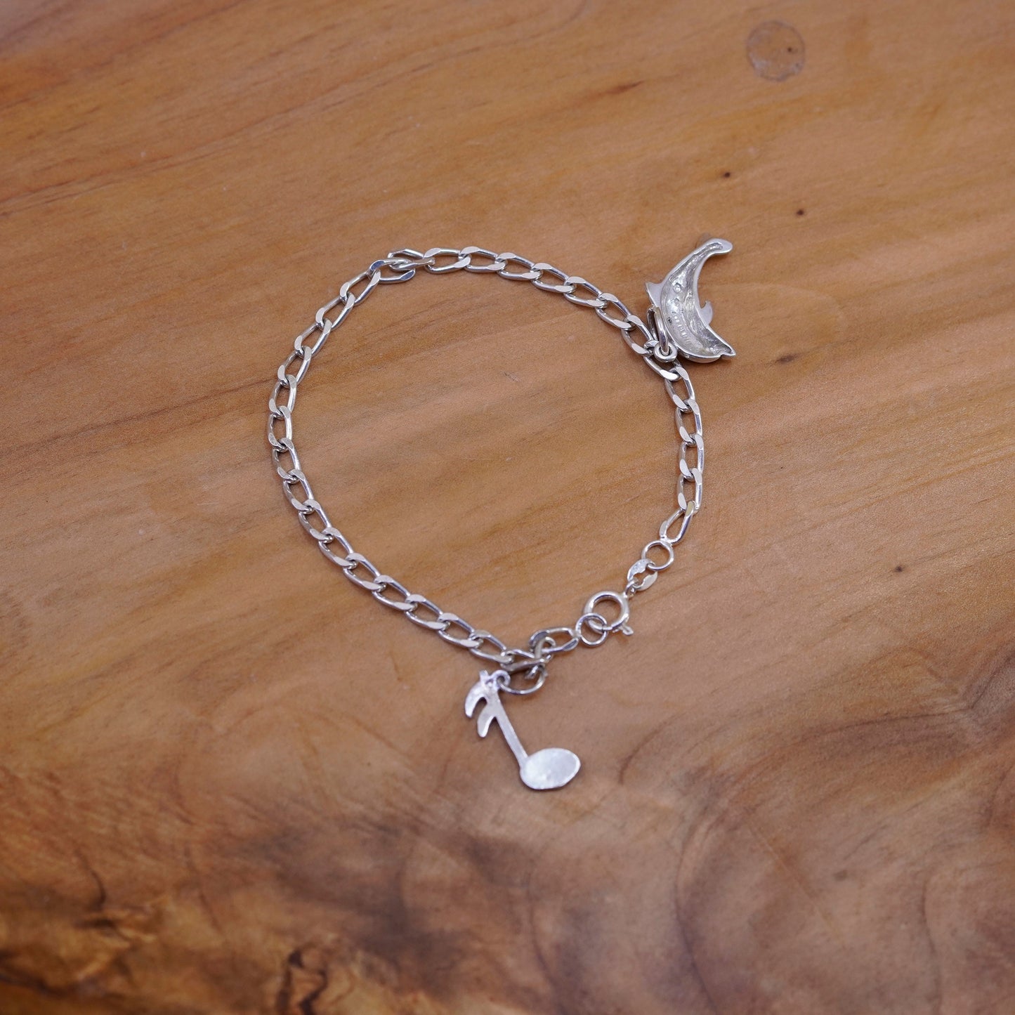 6.75”, Sterling silver bracelet, 925 curb chain with dolphin music note charms