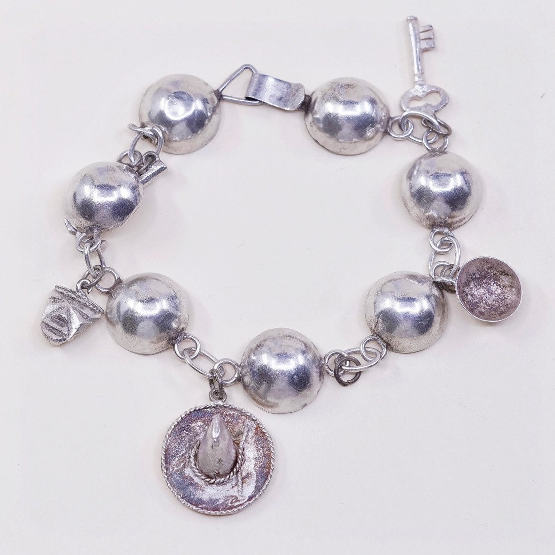 6”, sterling silver Handmade circle bracelet w/ hammer pot hat key sombrero