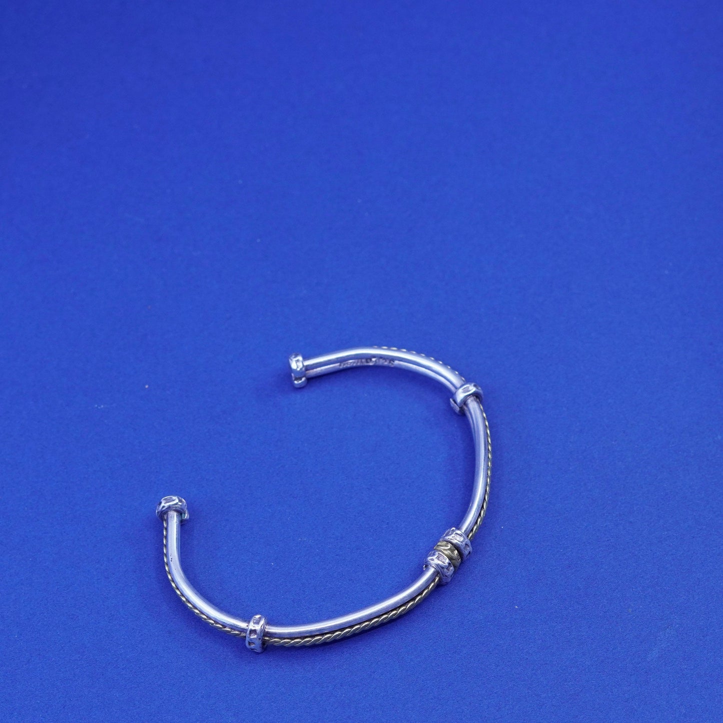 7.25”, two tone Sterling silver bracelet, ribbed 925 cuff with brass cable