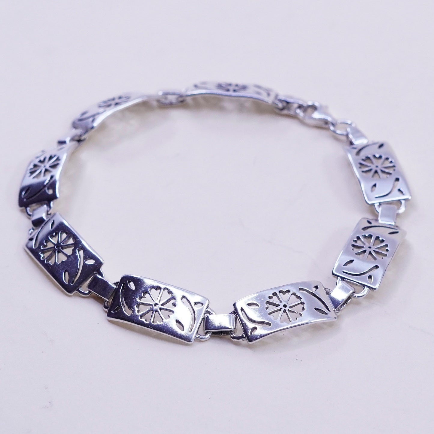 7.75”, sterling silver tennis bracelet, textured 925 chain with flower cut out