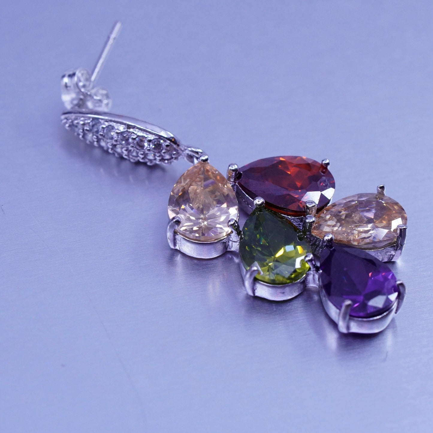 Silver tone earrings with teardrop colored cz